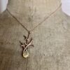 collier branche en vermeil rose opale d ethiopie | 26 Passage, Créatrice de bijoux à Paris Rose-gold necklace with a branching antler-like pendant and an oval opal gemstone displayed on a fabric dress form.